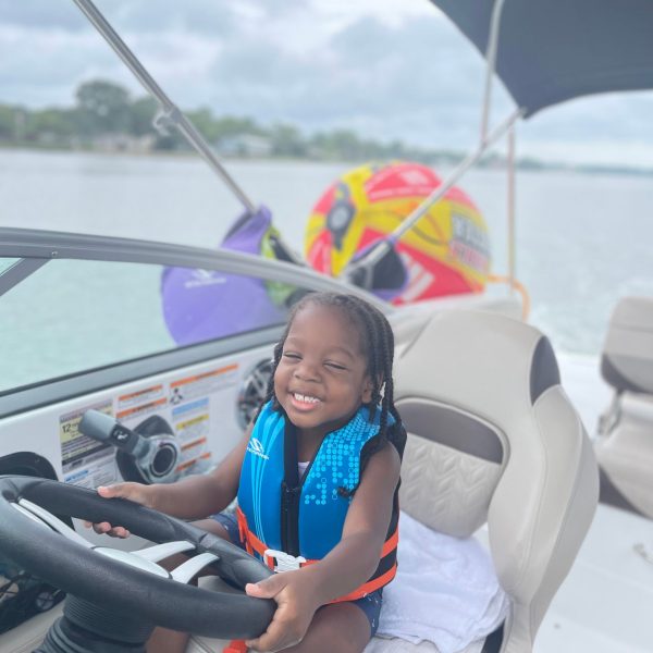 a little girl sitting in a car