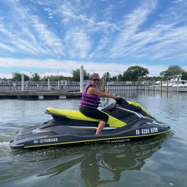 a person riding on the back of a boat in a body of water