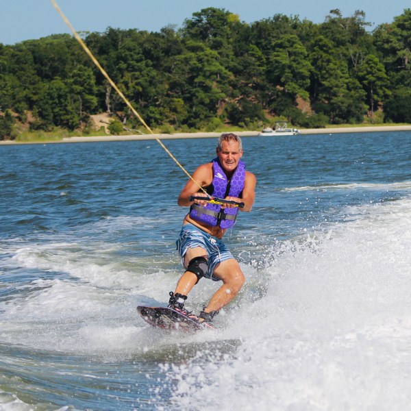 a man water skiing behind a boat