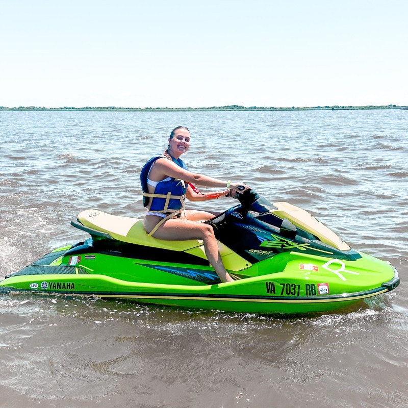a person riding on the back of a boat in the water