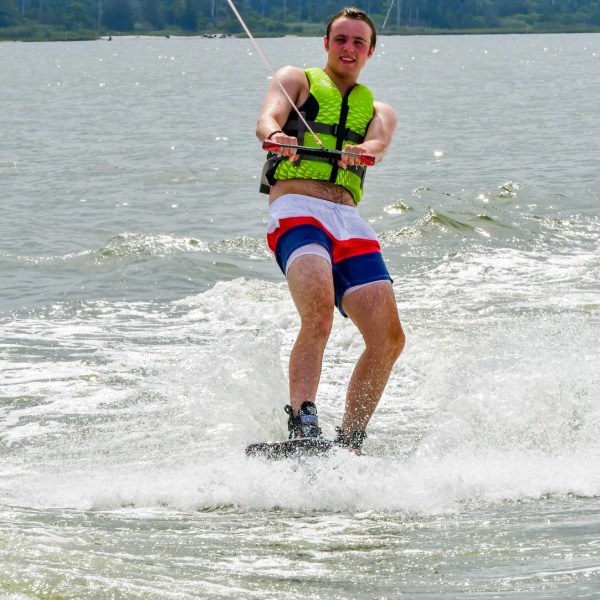 a man water skiing behind a boat on a body of water