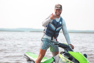 a person riding a surf board on a body of water