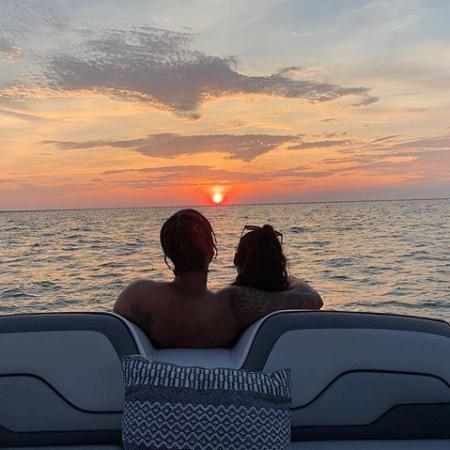 a person sitting on a beach near a body of water