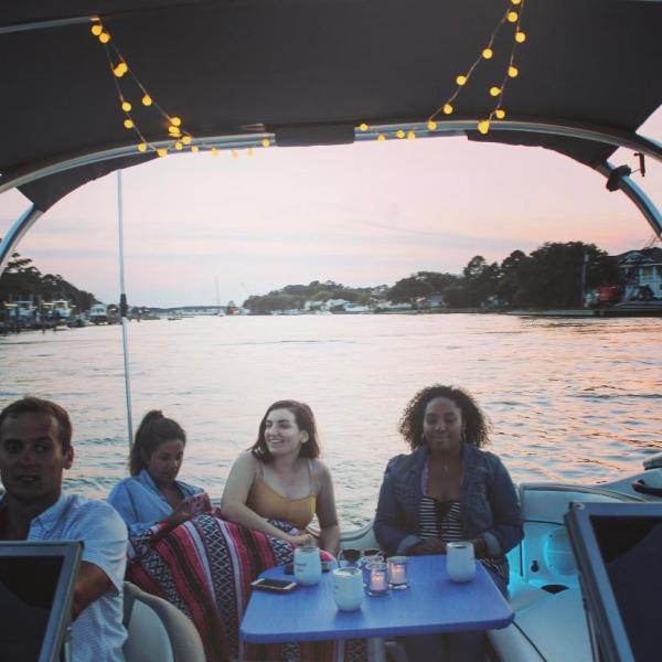 a group of people sitting in front of a body of water