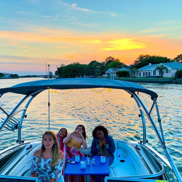 a group of people in a boat on a body of water