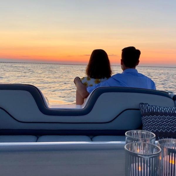 a person sitting next to a body of water