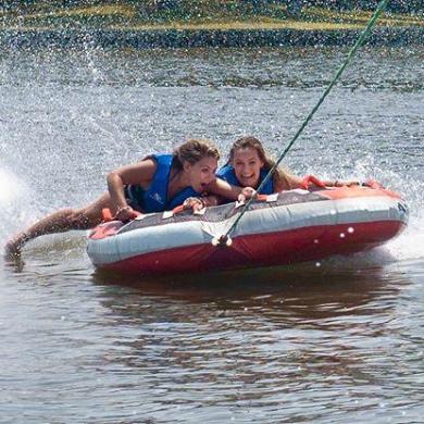 a person riding on the back of a boat in a body of water