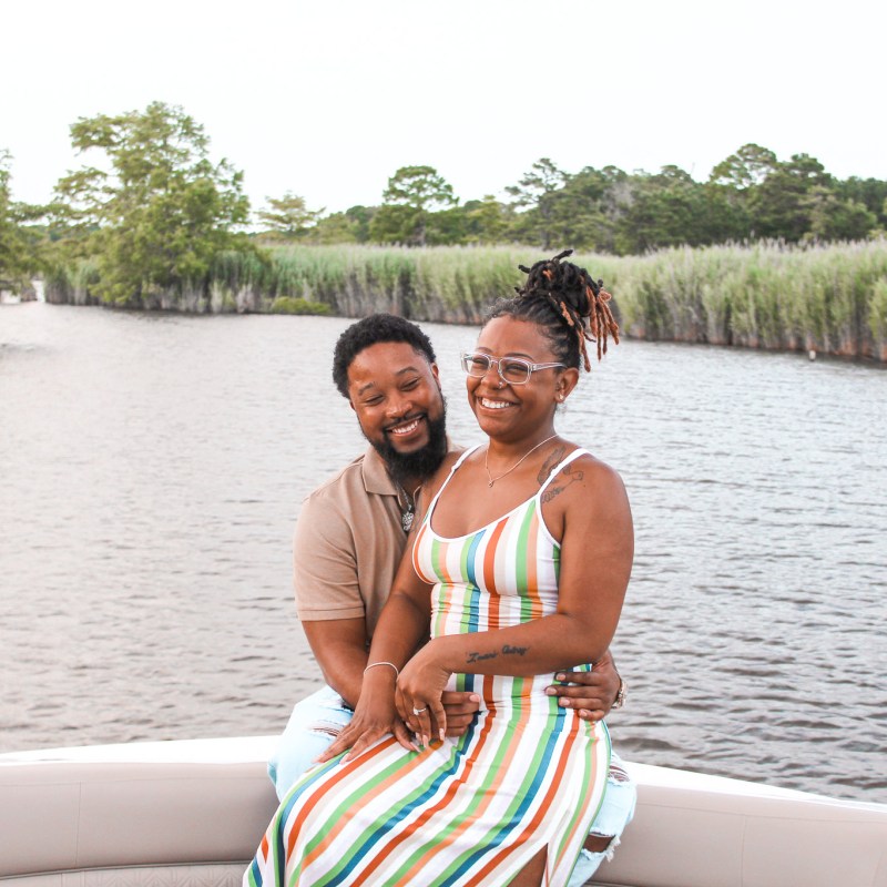 a person standing next to a body of water