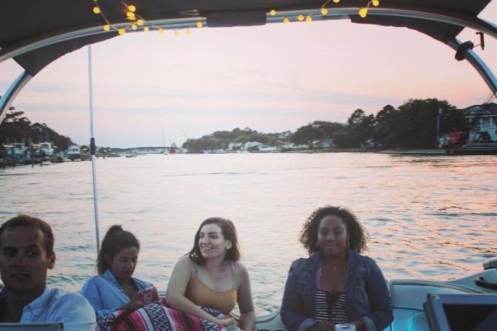 a group of people sitting in front of a body of water