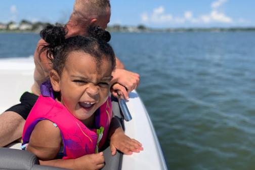 a person sitting in a boat on a body of water