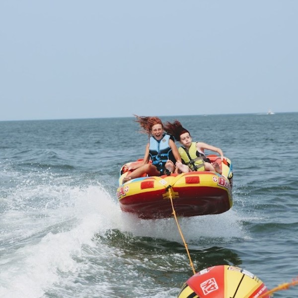 a man riding on the back of a boat in a body of water
