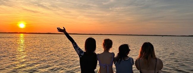 a man standing in front of a body of water