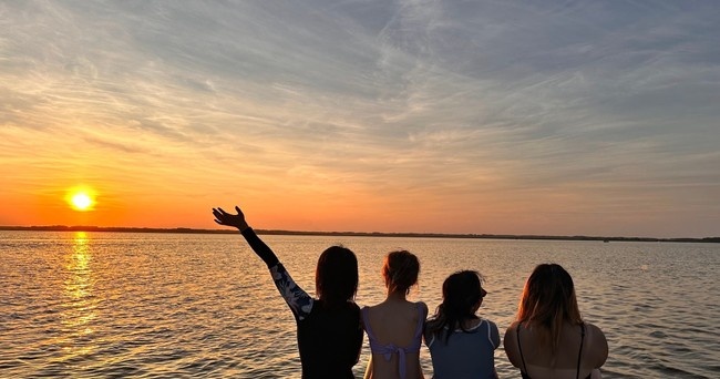 a man standing in front of a body of water