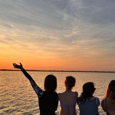 a man standing in front of a body of water