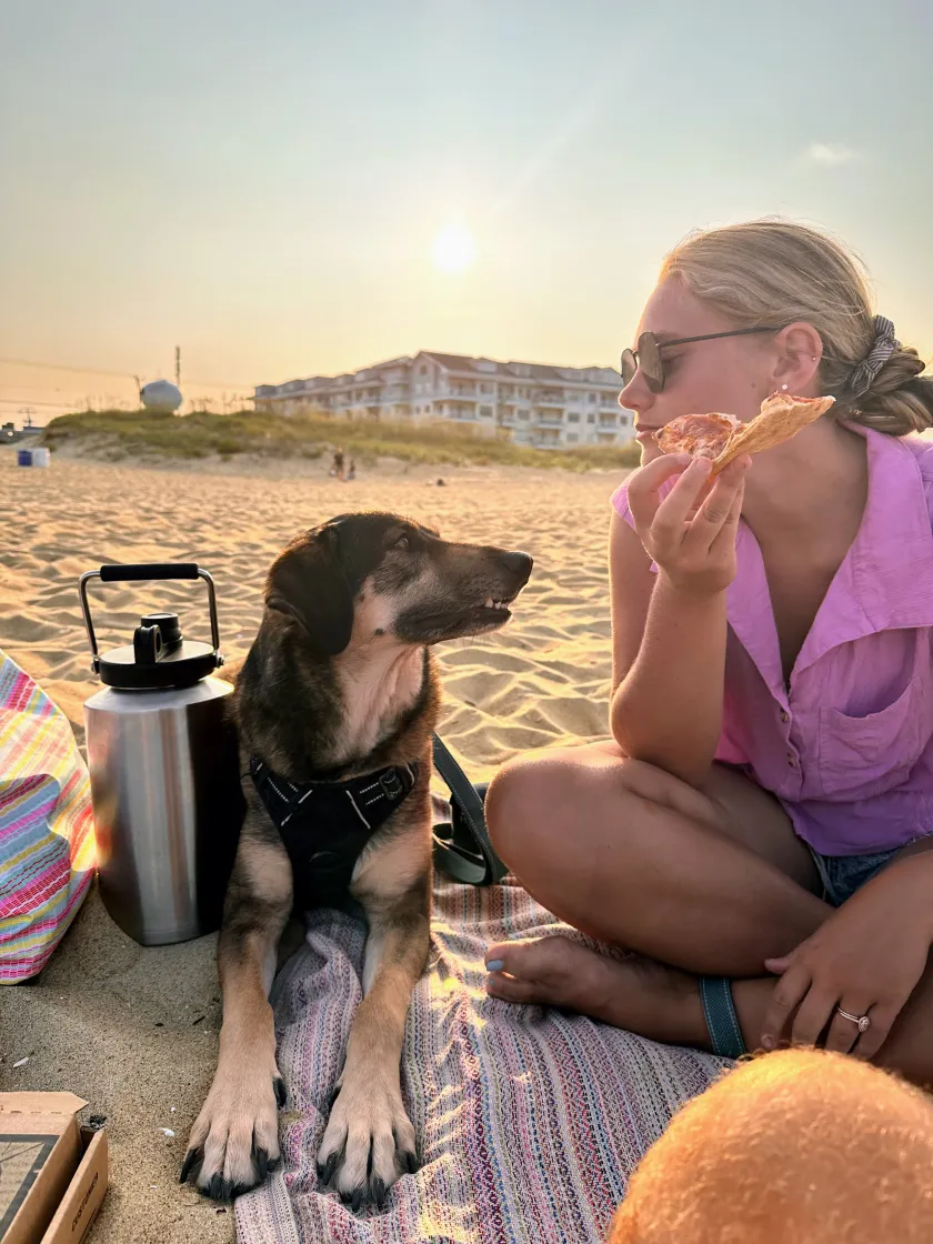a person sitting next to a dog